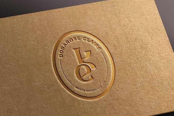 Blind-embossed monogram seal pressed into textured kraft packaging stock